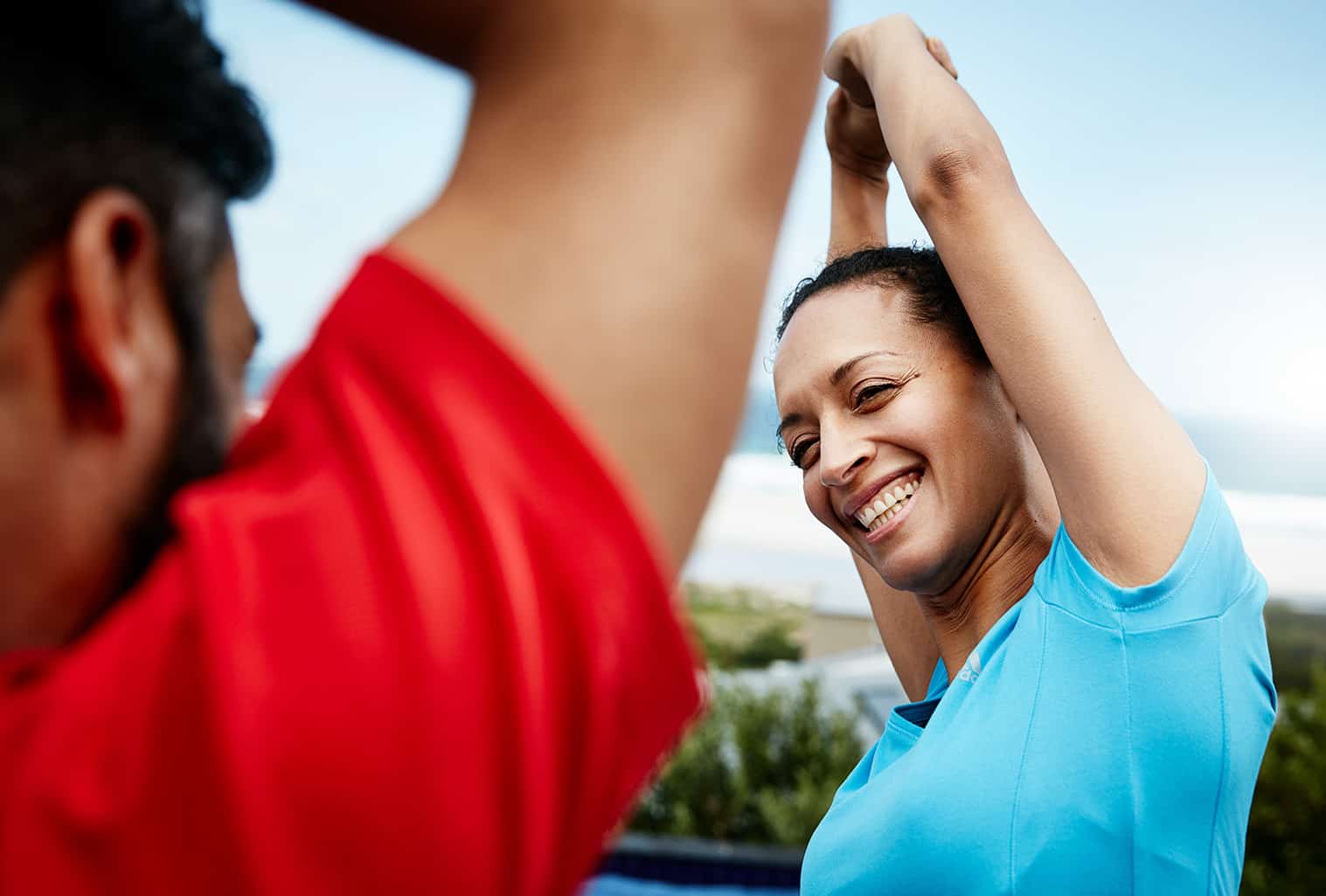 People smiling and stretching before workout